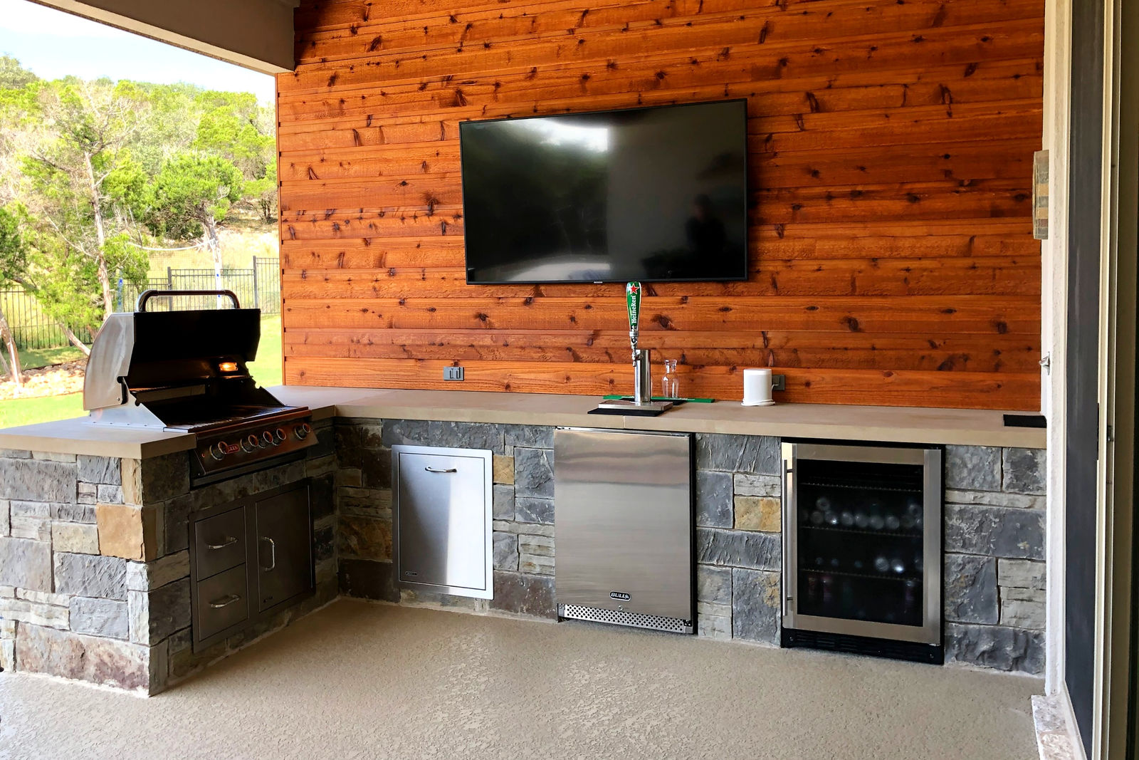 Hill Country outdoor kitchen — limestone veneer, built-in grill island